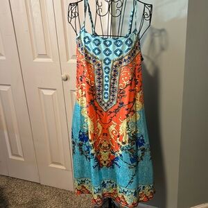 Multicolor sundress with pockets and spaghetti straps.